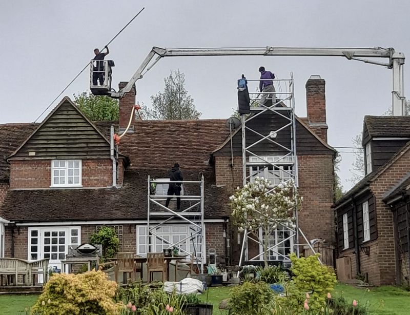 The Roof Moss Cleaners using cherry picker and scaffolding to clean roof safely and professionally in Southwick, West Sussex